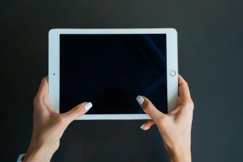 Tablet device, black screen on gray background Stock Photos