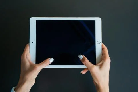 Tablet device, black screen on gray background Foto stock