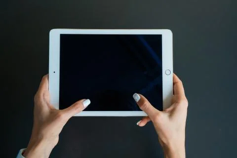 Tablet device, black screen on gray background Stock Photos