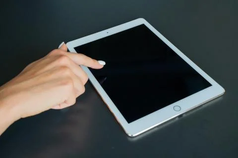 Tablet device, black screen on gray background Stock Photos