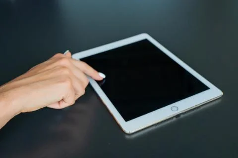 Tablet device, black screen on gray background Stock Photos