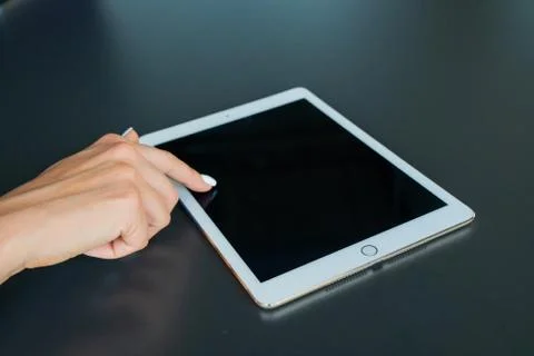 Tablet device, black screen on gray background Stock Photos