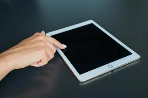 Tablet device, black screen on gray background Stock Photos
