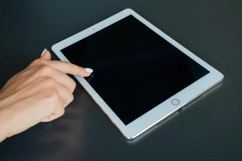 Tablet device, black screen on gray background Stock Photos