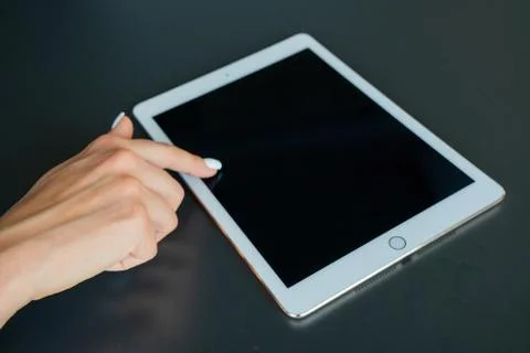 Tablet device, black screen on gray background Stock Photos