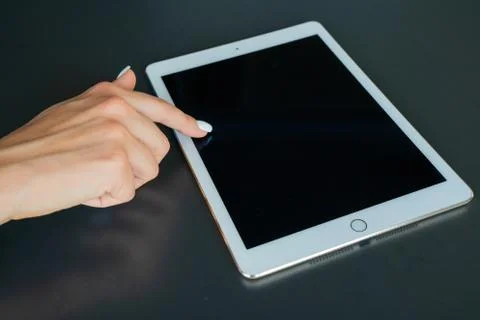 Tablet device, black screen on gray background Stock Photos