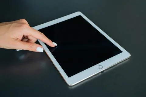 Tablet device, black screen on gray background Stock Photos