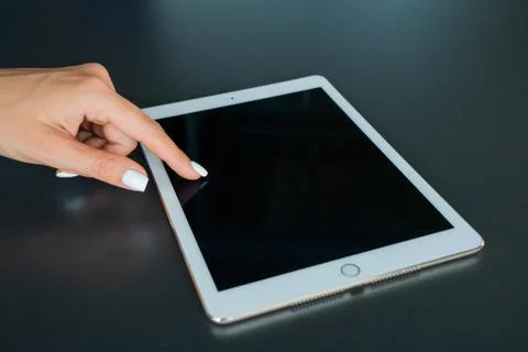 Tablet device, black screen on gray background Stock Photos