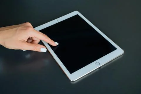Tablet device, black screen on gray background Stock Photos