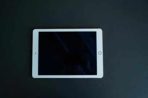 Tablet device, black screen on gray background Stock Photos