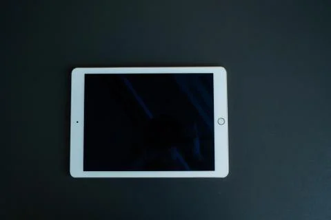 Tablet device, black screen on gray background Stock Photos