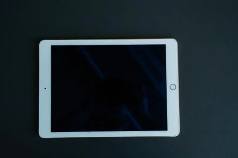 Tablet device, black screen on gray background Stock Photos