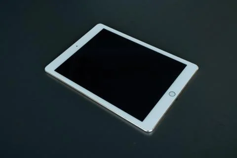 Tablet device, black screen on gray background Stock Photos