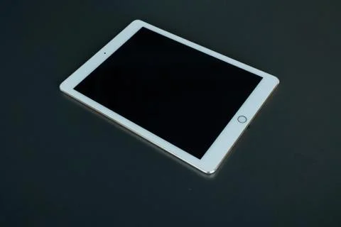 Tablet device, black screen on gray background Stock Photos