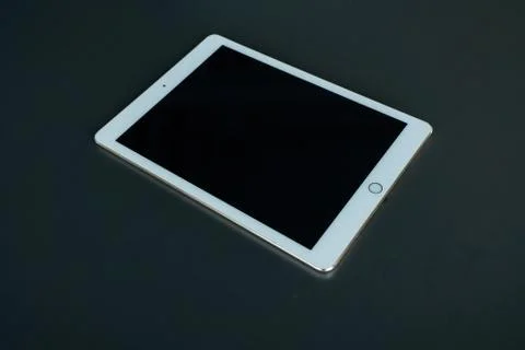 Tablet device, black screen on gray background Stock Photos