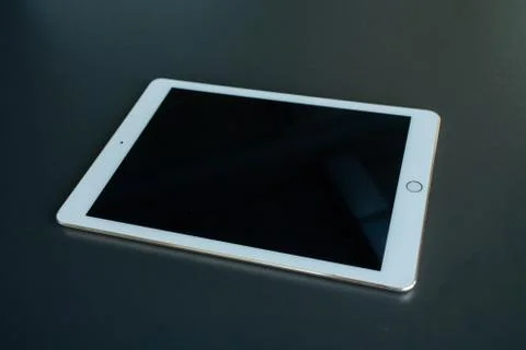 Tablet device, black screen on gray background Stock Photos
