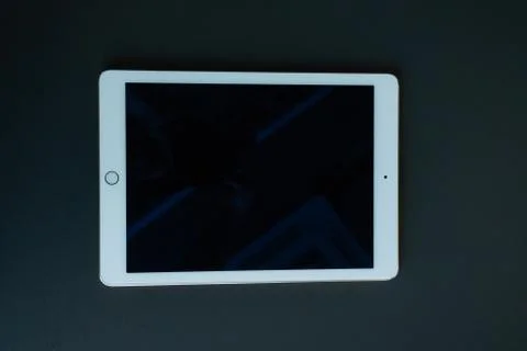 Tablet device, black screen on gray background Stock Photos