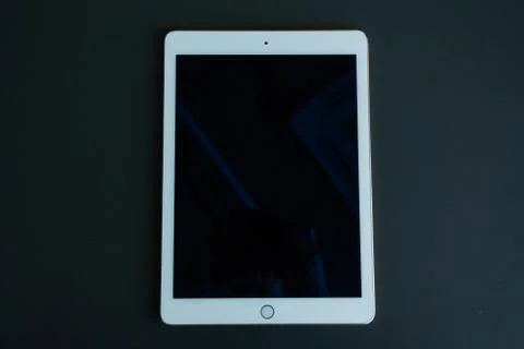 Tablet device, black screen on gray background Stock Photos