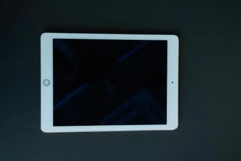 Tablet device, black screen on gray background Stock Photos