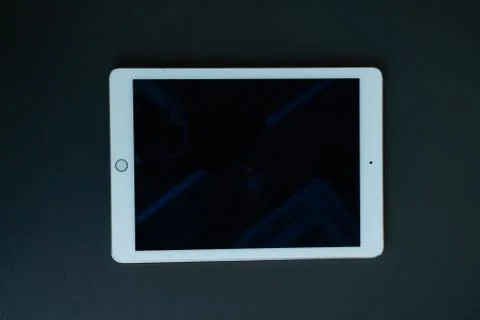 Tablet device, black screen on gray background Stock Photos