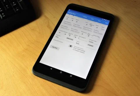 Tablet device on a desk running app Foto stock