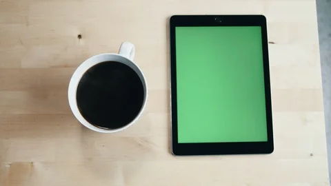 Tablet device green screen alongside coffee mug Stock-Footage 97735529