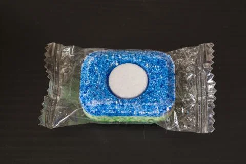 Tablet for Dishwashing Machine on a Black Background. Stock Photos