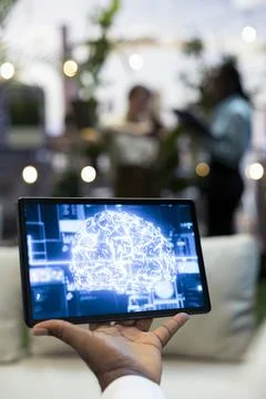Tablet displaying AI brain during rooftop business presentation Stock Photos