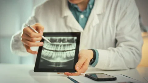 A tablet displaying a panoramic dental image sits in a dental office as a do Stock Footage 335124876