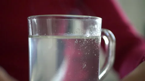 Tablet dissolves in a glass glass with water close-up Stock Footage 172523984