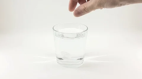 Tablet dissolves in a glass of water Stock Footage 124830765