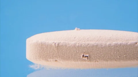 Tablet dissolves in water on blue background. 스톡 동영상 119088269