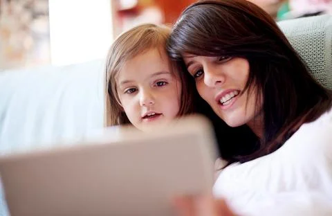 Tablet, elearning and mother with kid on sofa in living room for interactive Stock Photos