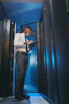 Tablet, engineer or black man in server room for firewall upgrade, software Stock Photos