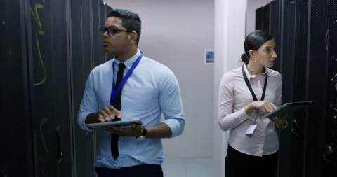 Tablet, engineering and server room, woman and man, teamwork and cybersecurity Stock Footage 243025077