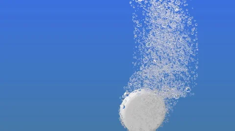 Tablet falls in liquid and allocates bleb to light blue background Stock Footage 60702787