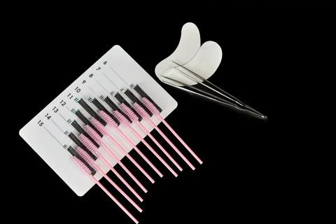 A tablet with false eyelashes, eyelash brushes and patches. Stock Photos