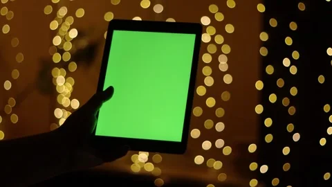 Tablet with Green Screen and Blurred Lights Stock Footage 339056653