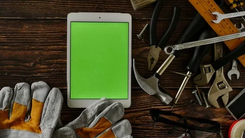 Tablet with green screen and construction tools on wooden table Stock Footage 92152107