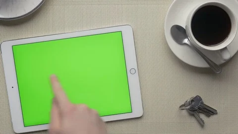 Tablet with green screen and a cup of coffee on a desktop Stock Footage 75459052