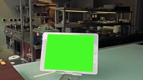 Tablet - green screen - empty professional restaurant kitchen in background 스톡 동영상 67430439