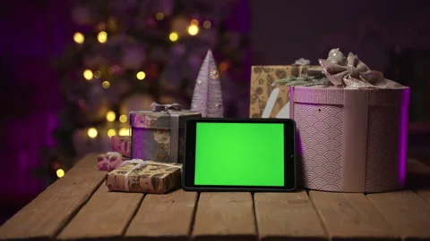 Tablet with green screen, gift box, Christmas tree. Happy New Year 2022 Stock-Footage 164625584