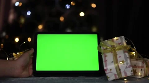 Tablet with green screen in hands on christmas background Stock-Footage 239699270