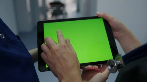 Tablet with a green screen in the hands of a nurse Stock Footage 230243673
