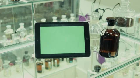 The tablet with the green screen on a show-window in shop of perfume Stock Footage 57851763