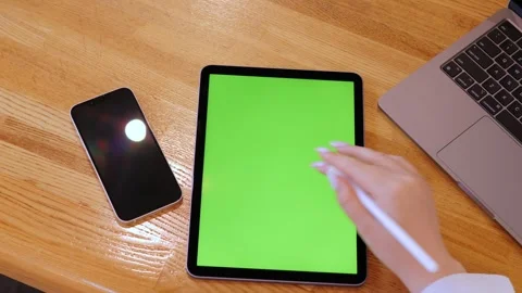 Tablet with green screen sits on wood Stock Footage 314410839
