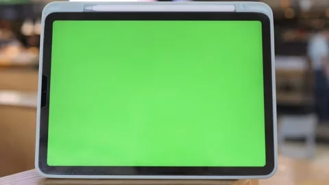 Tablet with green screen sits on wood Stock Footage 341490438