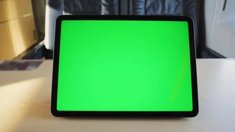 A tablet with a green screen on a table in a high-speed train car against the Stock Footage 310601250