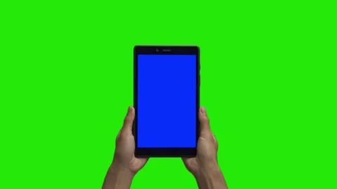 Tablet in the hand close up isolated at green background. Tablet screen is blue  Stock Footage 198296903