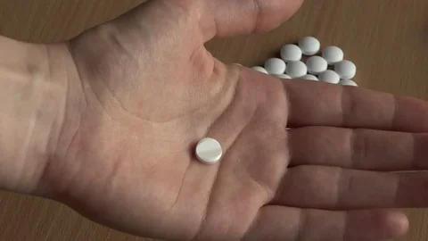 Tablet in hand. Heart made out of pills. Video stock 75198251
